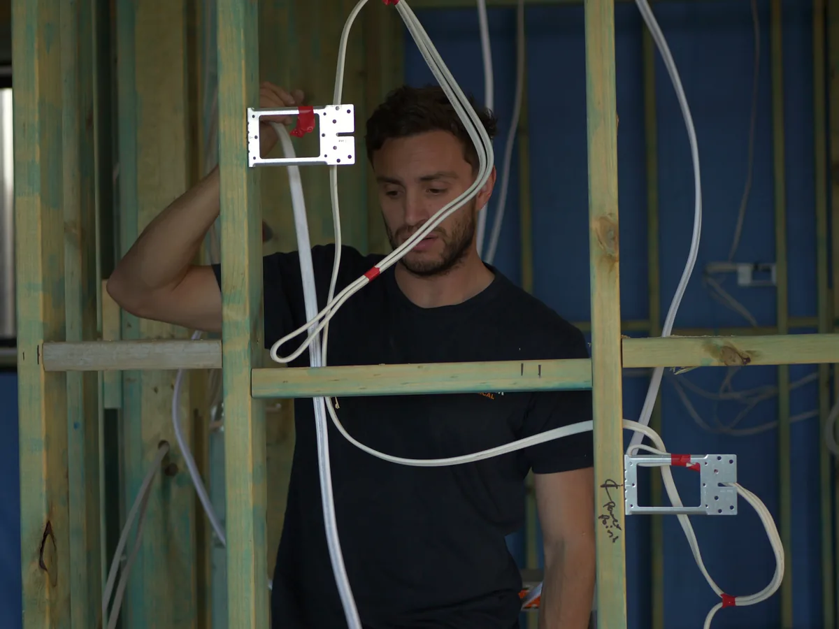 Electrical cabling being installed during a new-build rough-in